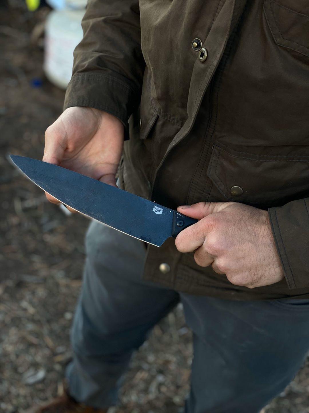 DFACKTO Chef Knife in hand while camping